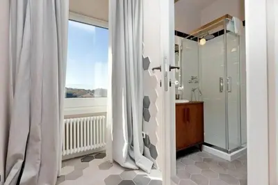 a bathroom with a shower and a shower curtain at Julie's Renovated View in Rome