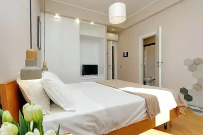 a bedroom with a large white bed and a television at Julie's Renovated View in Rome