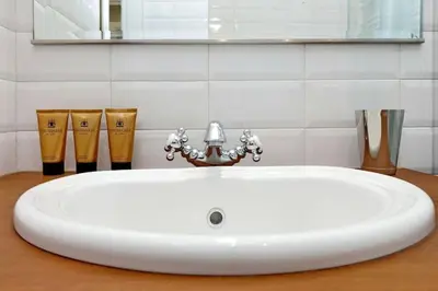 a white sink with a faucet in a bathroom at Julie's Renovated View in Rome