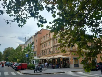 a building on a city street with a motorcycle parked in front at Mila House in Rome