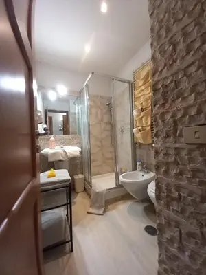 a bathroom with a shower and a toilet and a sink at Mila House in Rome