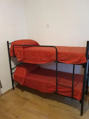 a bunk bed in a room with red sheets at La mandragola in Rome