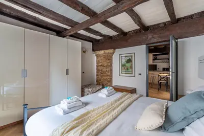 a bedroom with a large white bed in a room at iFlat Campo de Fiori's Comfy Gem in Rome