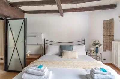 a bedroom with a bed with towels on it at iFlat Campo de Fiori's Comfy Gem in Rome