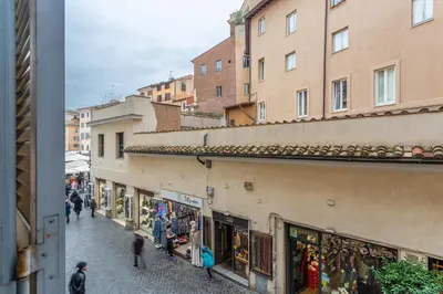 a group of people walking down a street next to buildings at iFlat Campo de Fiori's Comfy Gem in Rome