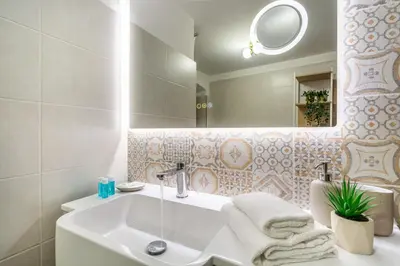 a bathroom with a sink and a mirror at iFlat Campo de Fiori's Comfy Gem in Rome
