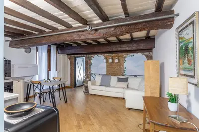 a living room with a white couch and a table at iFlat Campo de Fiori's Comfy Gem in Rome