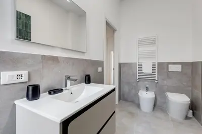 a bathroom with a sink and a toilet at BMGA l Aurelian 3Bdr 6-Guest Gem in Rome
