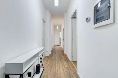 a hallway with white walls and a white table at BMGA l Aurelian 3Bdr 6-Guest Gem in Rome
