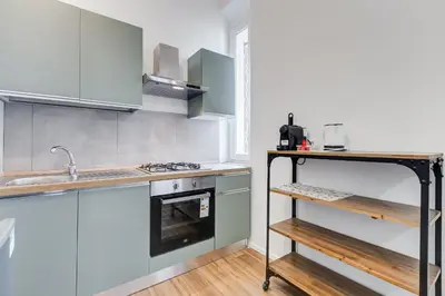 a kitchen with a sink and a stove top oven at BMGA l Aurelian 3Bdr 6-Guest Gem in Rome