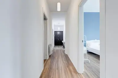 a corridor of a room with a bed and a mirror at BMGA l Aurelian 3Bdr 6-Guest Gem in Rome