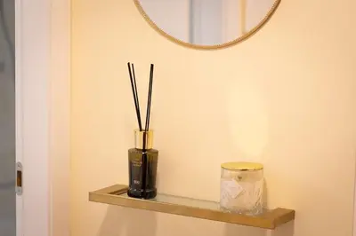 a vase with sticks in it sitting on a shelf at Dolcevita Vatican Apartment in Rome