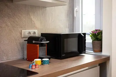a microwave sitting on top of a kitchen counter at Dolcevita Vatican Apartment in Rome