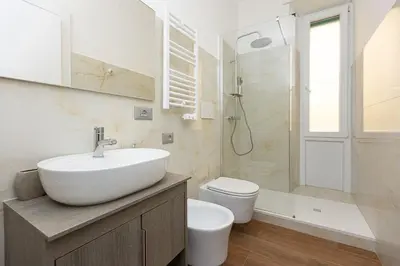 a bathroom with a sink and a toilet and a shower at Dolcevita Vatican Apartment in Rome