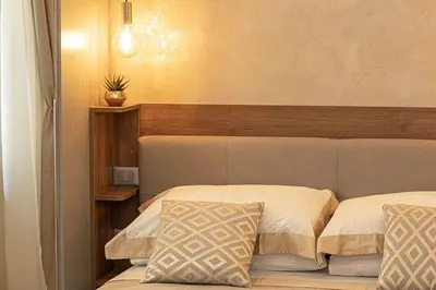 a bedroom with two beds with a headboard and avertisement at Dolcevita Vatican Apartment in Rome