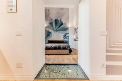 a hallway with a bed in the middle of a room at Via Nizza 126 Luxury in Rome