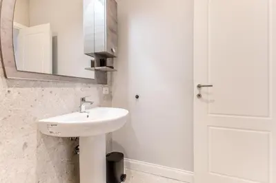 a white bathroom with a sink and a mirror at Via Nizza 126 Luxury in Rome