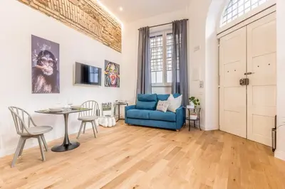 a living room with a blue couch and a table at Via Nizza 126 Luxury in Rome