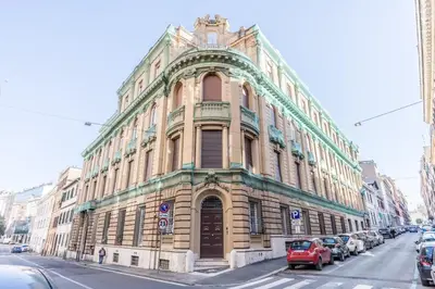a large building on a street with cars parked in front at Via Nizza 126 Luxury in Rome