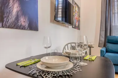 a dining room table with a bowl and glasses on it at Via Nizza 126 Luxury in Rome