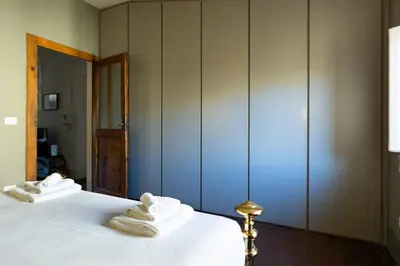 a bedroom with two beds with white towels on them at Attico Spazioso ed Elegante a Santa Maria Maggiore in Rome