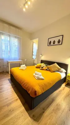a bedroom with a large bed with yellow sheets at Matilda House San Paolo Roma in Rome