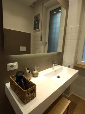a bathroom with a white sink and a mirror at Residenza Roma 19 in Rome