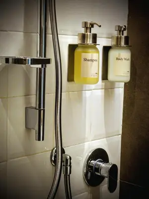 a bathroom with two soap dispensers on the wall at Residenza Roma 19 in Rome