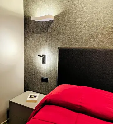 a bedroom with a red bed and a night stand at Residenza Roma 19 in Rome