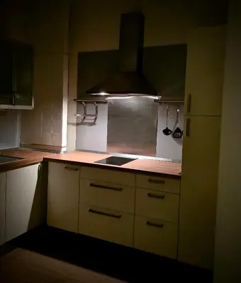 a small kitchen with white cabinets and a stove at Residenza Roma 19 in Rome