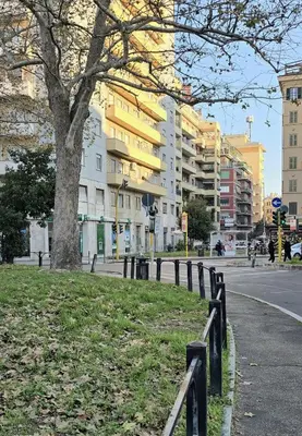 a park with a fence and a tree and buildings at Residenza Roma 19 in Rome