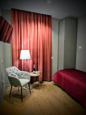 a bedroom with a bed and a chair and a table at Residenza Roma 19 in Rome