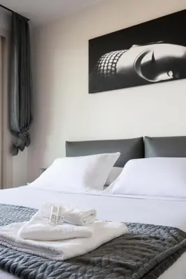 a hotel room with a bed with towels on it at Green park apartment in Rome