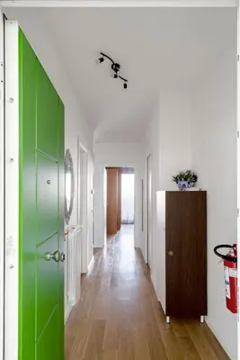 a hallway with a green door and white walls at Green park apartment in Rome