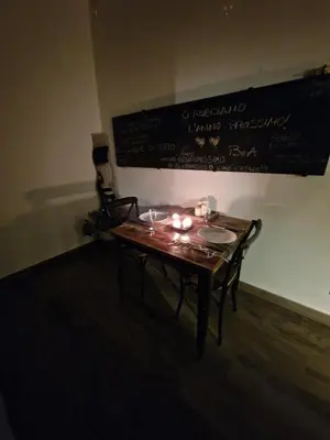 a wooden table with candles on it in a room at La casa Di Tommi a Ponte Milvio in Rome