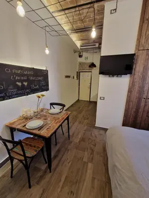 a room with a table and a bed and a chalkboard at La casa Di Tommi a Ponte Milvio in Rome