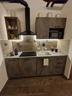 a kitchen with a sink and a stove at La casa Di Tommi a Ponte Milvio in Rome
