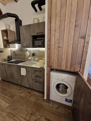 a kitchen with a washing machine and a sink at La casa Di Tommi a Ponte Milvio in Rome