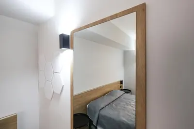 a mirror in front of a bedroom with a bed at Seven Kings Relais in Rome