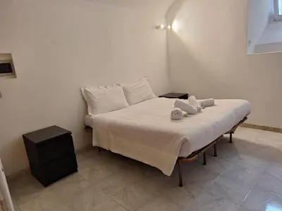 a bed with white sheets and pillows in a room at apt treviso house in Rome