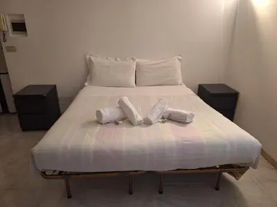 a bed with two pillows on top of it at apt treviso house in Rome