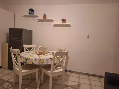 a kitchen with a table and chairs and a refrigerator at apt treviso house in Rome