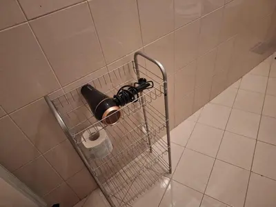 a wire basket with a roll of toilet paper at apt treviso house in Rome