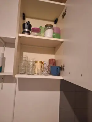a kitchen shelf with jars and other items on it at apt treviso house in Rome