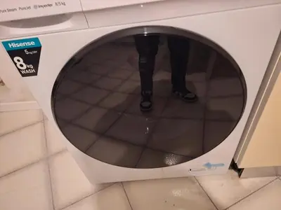 a person standing in front of a washing machine at apt treviso house in Rome