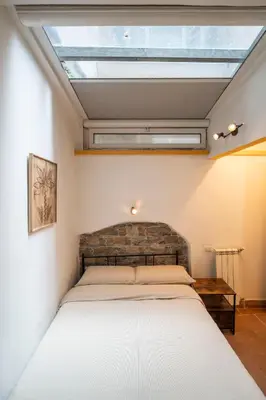 a bedroom with a bed with a skylight at Home d'Elite Sistina - Trevi Fountain in Rome