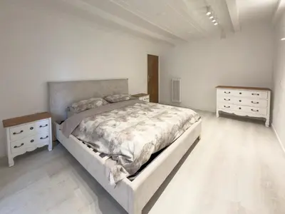 a white bedroom with a large bed and a window at Home d'Elite Sistina - Trevi Fountain in Rome