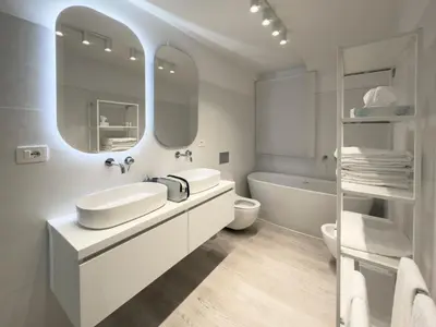 a bathroom with two sinks and a tub and a mirror at Home d'Elite Sistina - Trevi Fountain in Rome