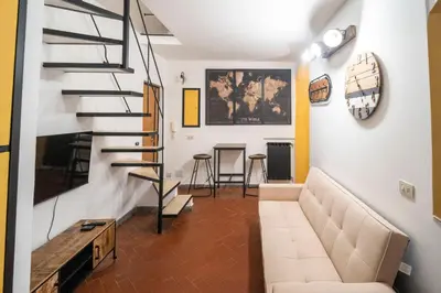 a table and two stools under a map on a wall at Home d'Elite Sistina - Trevi Fountain in Rome