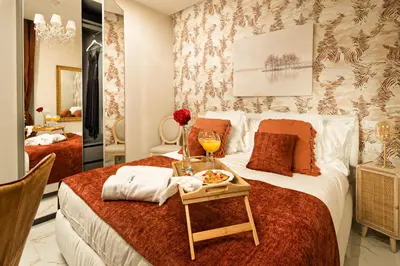 a hotel room with a bed with a tray of food on it at VATICANO 13 Guest House in Rome